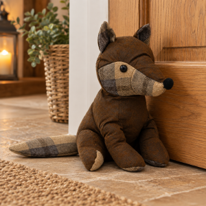 ChatGPT Image Sep 29 2026 02_28_34 PM - Butterflygifts Ltd Brown plaid plush fox toy sitting on a tile floor beside a wooden door in a cozy entryway.