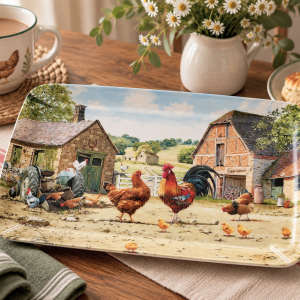 Decorative farm-scene plate with roosters, chickens, and rustic barns on a table setting.