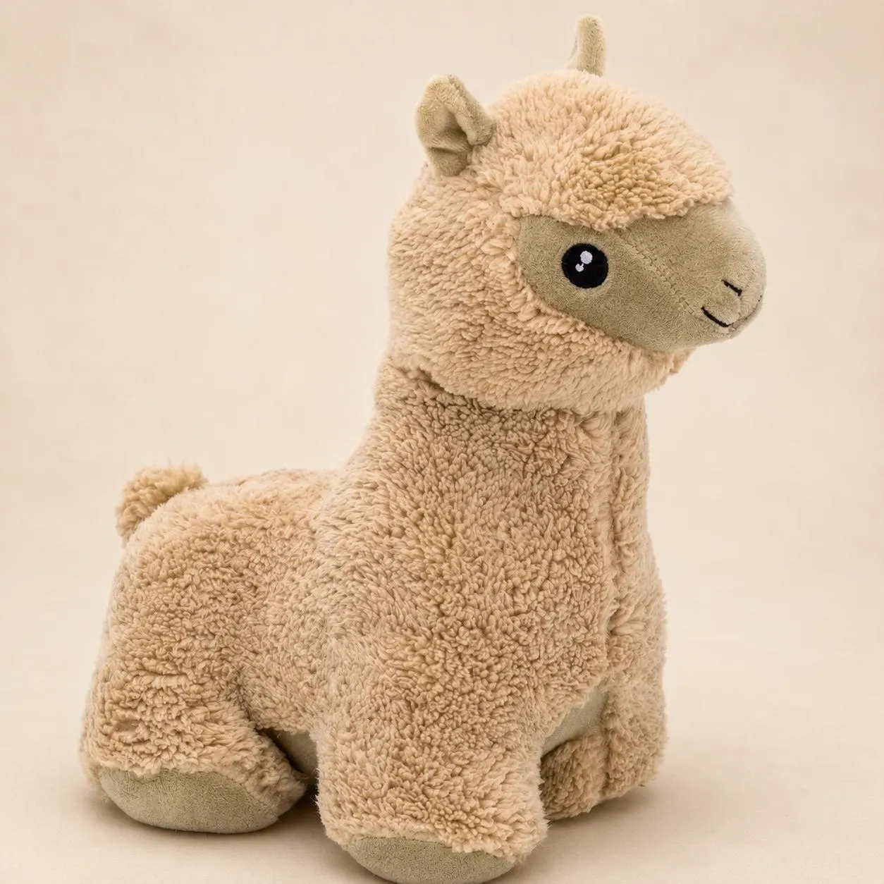 il_fullxfull8317802710_lsqi - Butterflygifts Ltd Beige plush llama toy sitting upright against a neutral background, with fluffy fur and stitched smile.