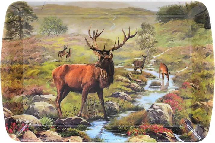 small-tray-highland-burn - Butterflygifts Ltd Pastoral painting of a red deer by a winding stream in a rocky, flowering landscape with more deer in the distance.