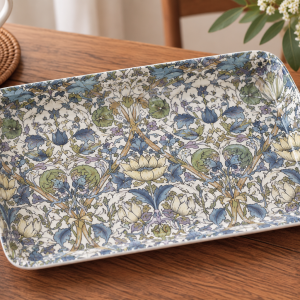Rectangular ceramic serving dish with a blue, green, and cream floral pattern on a wooden table.