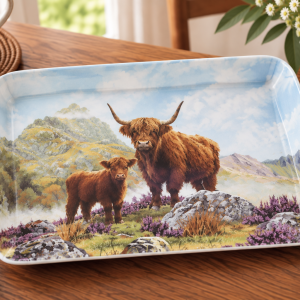Decorative tray with a Highland cattle pair standing on rocky moor under a blue sky.